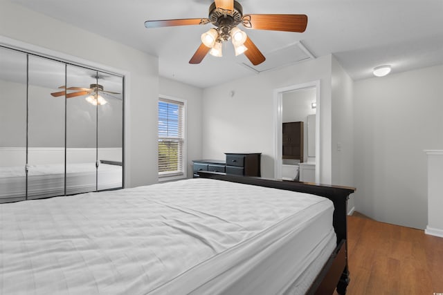 6500 Colonial Dr Unit 2, Myrtle Beach, SC 29572 - bedroom featuring wood finished floors, a ceiling fan, a closet, and connected bathroom