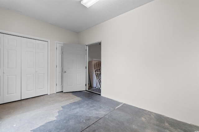 6500 Colonial Dr Unit 2, Myrtle Beach, SC 29572 - unfurnished bedroom featuring concrete floors and a closet