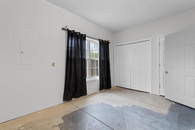 6500 Colonial Dr Unit 2, Myrtle Beach, SC 29572 - unfurnished bedroom featuring electric panel, a closet, and concrete flooring