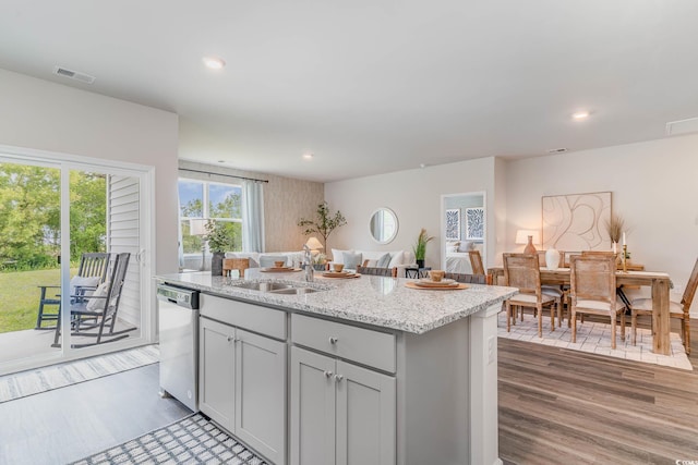 2889 Riverboat Way, Conway, SC 29526 - kitchen featuring dishwasher, wood finished floors, a kitchen island with sink, light stone counters, and recessed lighting