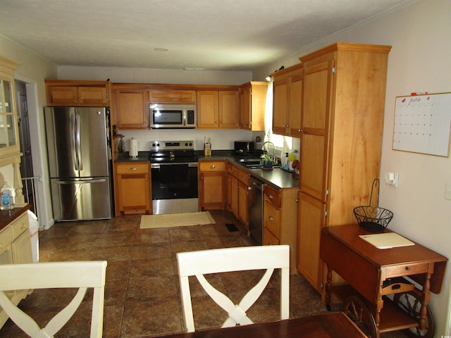 5578 Dongola Hwy, Conway, SC 29527 - kitchen with appliances with stainless steel finishes, a sink, dark countertops, and brown cabinets
