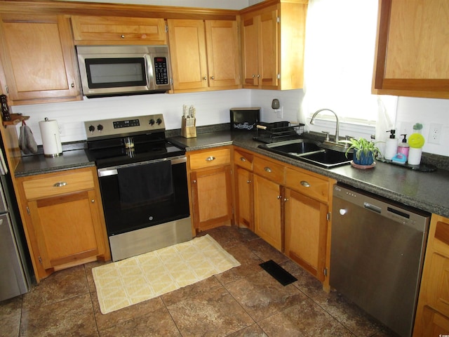 5578 Dongola Hwy, Conway, SC 29527 - kitchen with stainless steel appliances, a sink, dark countertops, and dark stone finish flooring