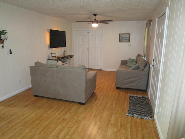 5578 Dongola Hwy, Conway, SC 29527 - living area featuring light wood-style flooring, a textured ceiling, a ceiling fan, and baseboards