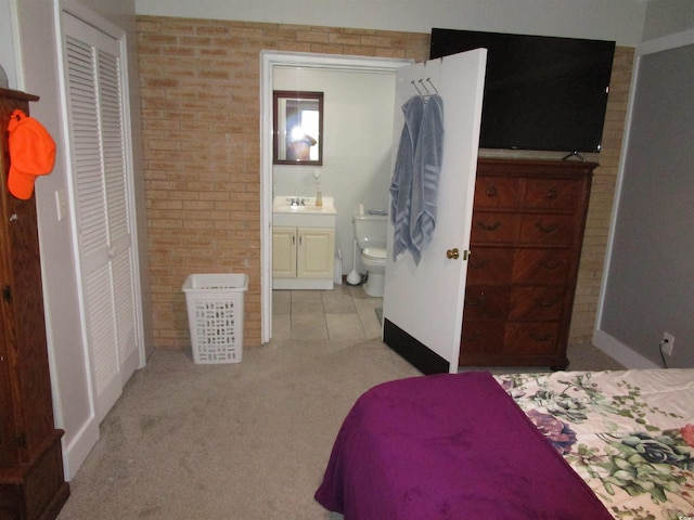 5578 Dongola Hwy, Conway, SC 29527 - carpeted bedroom featuring brick wall, a sink, connected bathroom, and baseboards