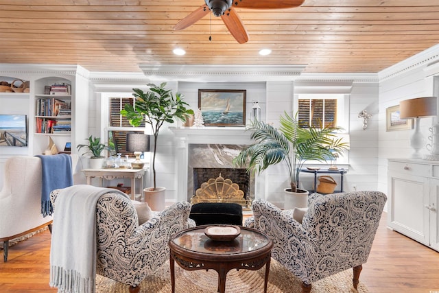 309 Sunset Trl, Myrtle Beach, SC 29577 - living area with wood ceiling, light wood-type flooring, ceiling fan, a premium fireplace, and crown molding