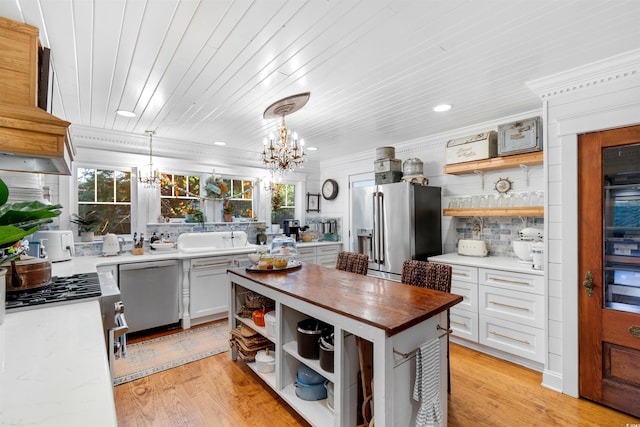 309 Sunset Trl, Myrtle Beach, SC 29577 - kitchen with open shelves, stainless steel appliances, wood counters, a chandelier, and plenty of natural light