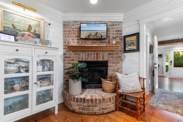 309 Sunset Trl, Myrtle Beach, SC 29577 - living room with crown molding, hardwood / wood-style floors, a fireplace, and wood walls