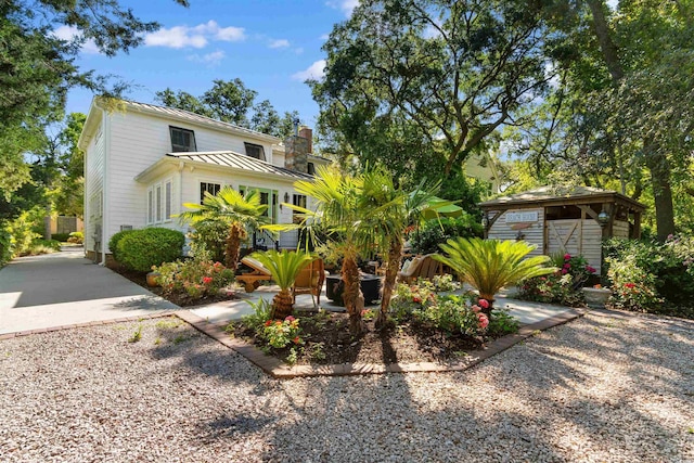 309 Sunset Trl, Myrtle Beach, SC 29577 - view of front of house with a standing seam roof, metal roof, and a chimney