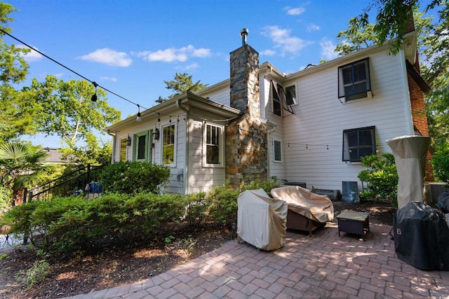 309 Sunset Trl, Myrtle Beach, SC 29577 - rear view of house featuring a chimney, a patio, and outdoor lounge area