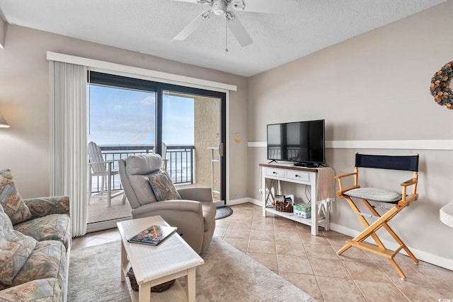 4000 N Ocean Blvd Unit 506, North Myrtle Beach, SC 29582 - tiled living area with a ceiling fan, a textured ceiling, and baseboards