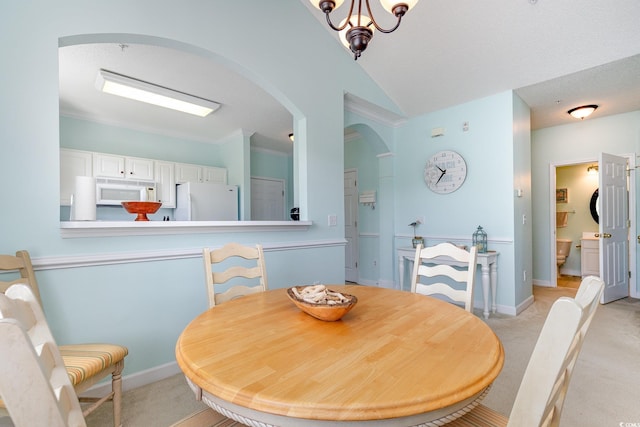 6015 Catalina Dr Unit 134, North Myrtle Beach, SC 29582 - dining space featuring arched walkways, light colored carpet, a chandelier, vaulted ceiling, and baseboards