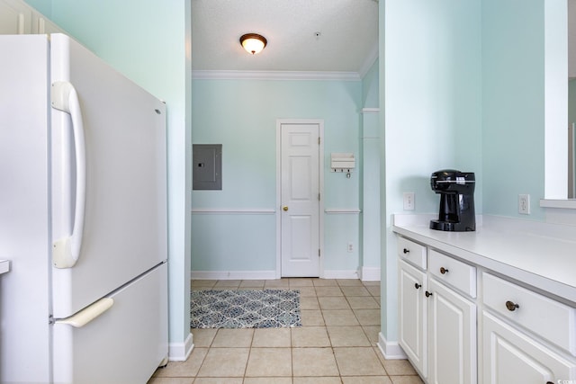 6015 Catalina Dr Unit 134, North Myrtle Beach, SC 29582 - kitchen with freestanding refrigerator, electric panel, light tile patterned flooring, crown molding, and white cabinetry