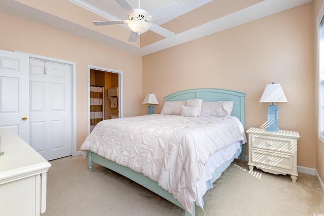 6015 Catalina Dr Unit 134, North Myrtle Beach, SC 29582 - bedroom with light colored carpet, baseboards, a ceiling fan, and connected bathroom