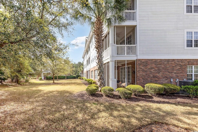 6015 Catalina Dr Unit 134, North Myrtle Beach, SC 29582 - view of home's exterior with brick siding and a lawn