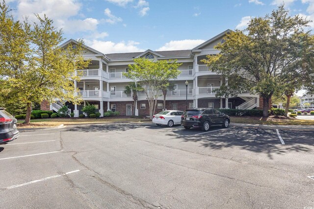 6015 Catalina Dr Unit 134, North Myrtle Beach, SC 29582 - view of building exterior featuring uncovered parking
