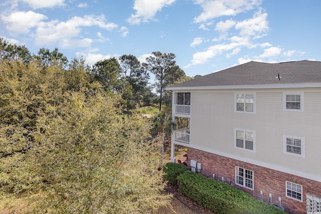 6015 Catalina Dr Unit 134, North Myrtle Beach, SC 29582 - view of property exterior with a balcony and brick siding