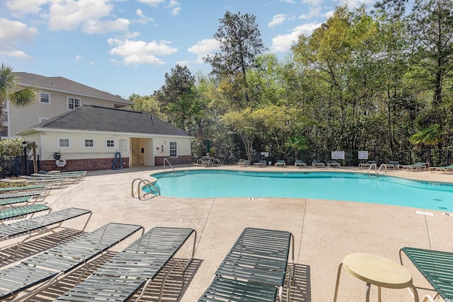 6015 Catalina Dr Unit 134, North Myrtle Beach, SC 29582 - community pool featuring a patio and view of scattered trees