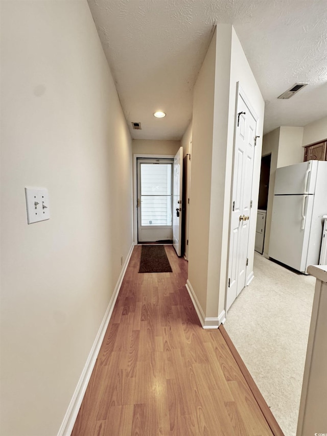 665 Tupelo Ln Unit 17-D, Longs, SC 29568 - corridor with light wood-style floors, baseboards, and a textured ceiling
