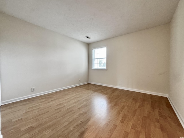 665 Tupelo Ln Unit 17-D, Longs, SC 29568 - empty room featuring wood finished floors, baseboards, and a textured ceiling
