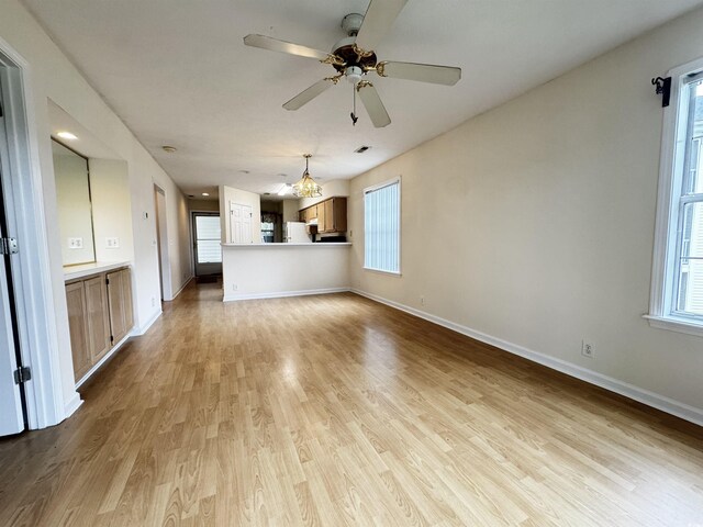 665 Tupelo Ln Unit 17-D, Longs, SC 29568 - unfurnished living room with light wood-type flooring, a chandelier, a ceiling fan, and baseboards