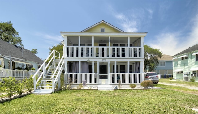 401 17th Ave S, North Myrtle Beach, SC 29582 - rear view of property featuring a porch, a lawn, and stairs