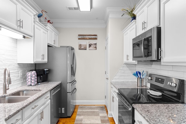 186 Ella Kinley Cir Unit 101, Myrtle Beach, SC 29588 - kitchen featuring stainless steel appliances, a sink, white cabinetry, tasteful backsplash, and crown molding