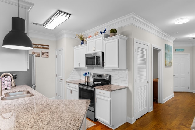 186 Ella Kinley Cir Unit 101, Myrtle Beach, SC 29588 - kitchen featuring appliances with stainless steel finishes, a sink, dark wood finished floors, white cabinetry, and backsplash