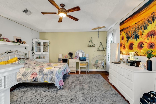 156 Hummingbird Ct, Myrtle Beach, SC 29579 - bedroom with a textured ceiling, wood finished floors, and a ceiling fan