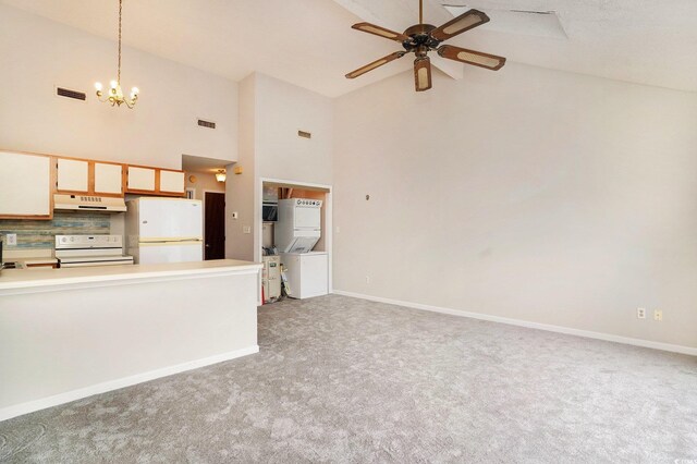 510 Fairwood Lakes Dr Unit 18N, Myrtle Beach, SC 29577 - unfurnished living room with ceiling fan, light carpet, high vaulted ceiling, a chandelier, and stacked washer and clothes dryer