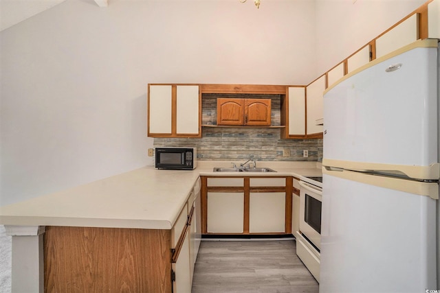 510 Fairwood Lakes Dr Unit 18N, Myrtle Beach, SC 29577 - kitchen with white appliances, decorative backsplash, a sink, light countertops, and high vaulted ceiling