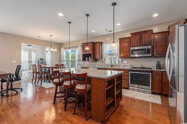 15 Saltwind Loop, Murrells Inlet, SC 29576 - kitchen featuring appliances with stainless steel finishes, open shelves, a sink, a kitchen island, and recessed lighting