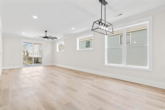 4617 Hedrick St, North Myrtle Beach, SC 29582 - unfurnished living room with a chandelier, crown molding, light wood-style floors, recessed lighting, and ceiling fan