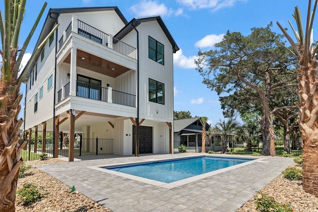 4617 Hedrick St, North Myrtle Beach, SC 29582 - rear view of property with a balcony, board and batten siding, and a patio
