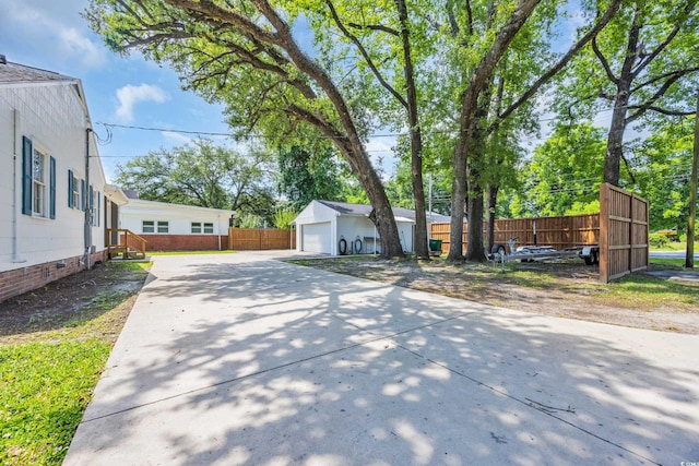 1155 Palmetto St, Georgetown, SC 29440 - view of yard featuring an outbuilding, driveway, and a garage