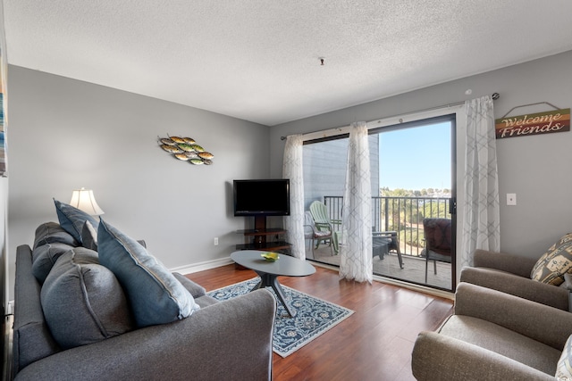 5905 S Kings Hwy Unit 242B, Myrtle Beach, SC 29575 - living area featuring wood finished floors, a textured ceiling, and baseboards