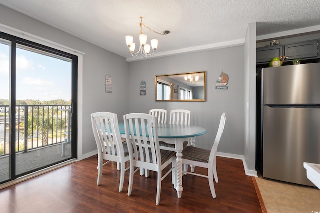 5905 S Kings Hwy Unit 242B, Myrtle Beach, SC 29575 - dining area with a chandelier, baseboards, wood finished floors, and a textured ceiling