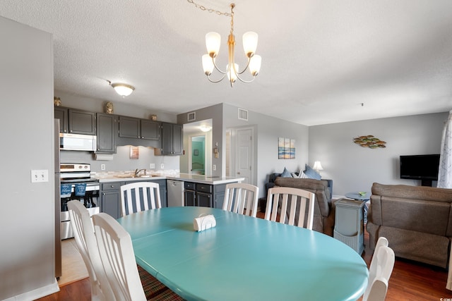 5905 S Kings Hwy Unit 242B, Myrtle Beach, SC 29575 - dining area featuring a chandelier, dark wood-type flooring, and baseboards