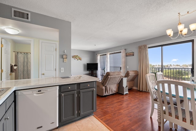 5905 S Kings Hwy Unit 242B, Myrtle Beach, SC 29575 - kitchen with dishwasher, a chandelier, gray cabinetry, light countertops, and a textured ceiling