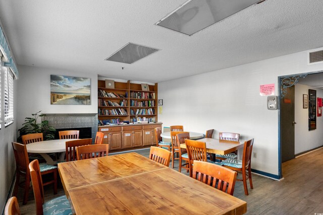 5905 S Kings Hwy Unit 242B, Myrtle Beach, SC 29575 - dining room with wood finished floors, a textured ceiling, and baseboards