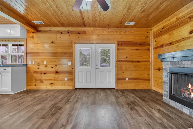 1039 Forest Dr, Conway, SC 29526 - unfurnished living room with wood ceiling, wood walls, a fireplace, wood finished floors, and ceiling fan