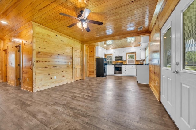 1039 Forest Dr, Conway, SC 29526 - unfurnished living room with wood ceiling, ceiling fan, dark wood-style flooring, and wood walls