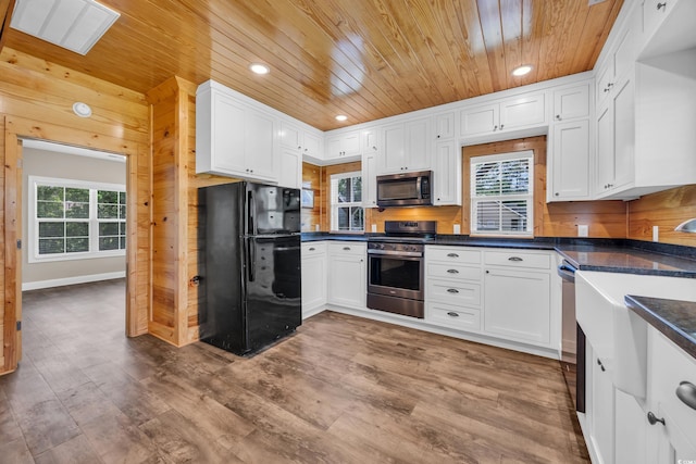 1039 Forest Dr, Conway, SC 29526 - kitchen with stainless steel appliances, wooden ceiling, white cabinetry, dark countertops, and wood finished floors