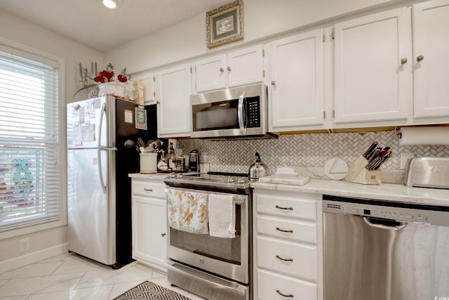 4396 Baldwin Ave Unit 1, Little River, SC 29566 - kitchen featuring stainless steel appliances, tasteful backsplash, white cabinetry, and baseboards