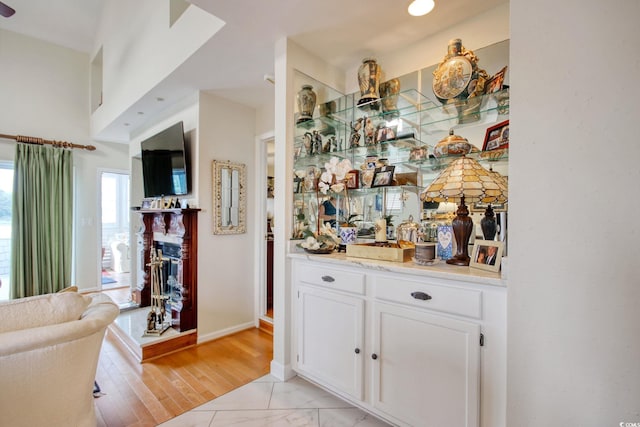4396 Baldwin Ave Unit 1, Little River, SC 29566 - bar area with a fireplace, light marble finish flooring, and baseboards
