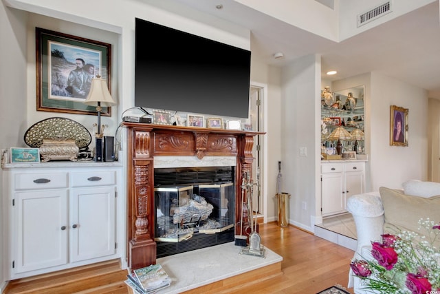 4396 Baldwin Ave Unit 1, Little River, SC 29566 - living room featuring a premium fireplace, light wood-style floors, and recessed lighting