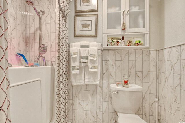 4396 Baldwin Ave Unit 1, Little River, SC 29566 - bathroom featuring toilet, a tile shower, and tile walls