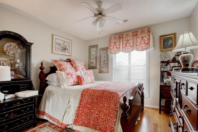 4396 Baldwin Ave Unit 1, Little River, SC 29566 - bedroom featuring light wood-style flooring, a textured ceiling, a ceiling fan, and baseboards