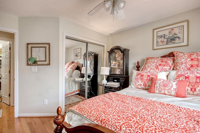 4396 Baldwin Ave Unit 1, Little River, SC 29566 - bedroom featuring wood finished floors, a closet, baseboards, ceiling fan, and a textured ceiling