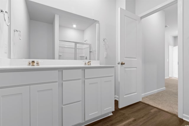 786 NW Palm Frond Way Unit 51, Calabash, NC 28467 - bathroom with double vanity, an enclosed shower, wood finished floors, and baseboards
