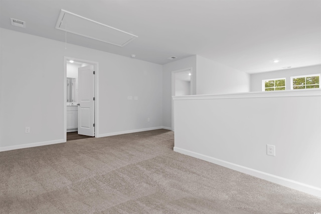 786 NW Palm Frond Way Unit 51, Calabash, NC 28467 - unfurnished room with attic access, carpet floors, and baseboards